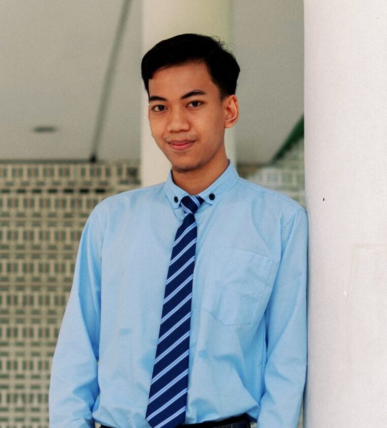 Man in formal attire posing confidently.